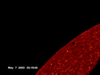 The dark spot is Mercury, just as it passes over the solar disk.