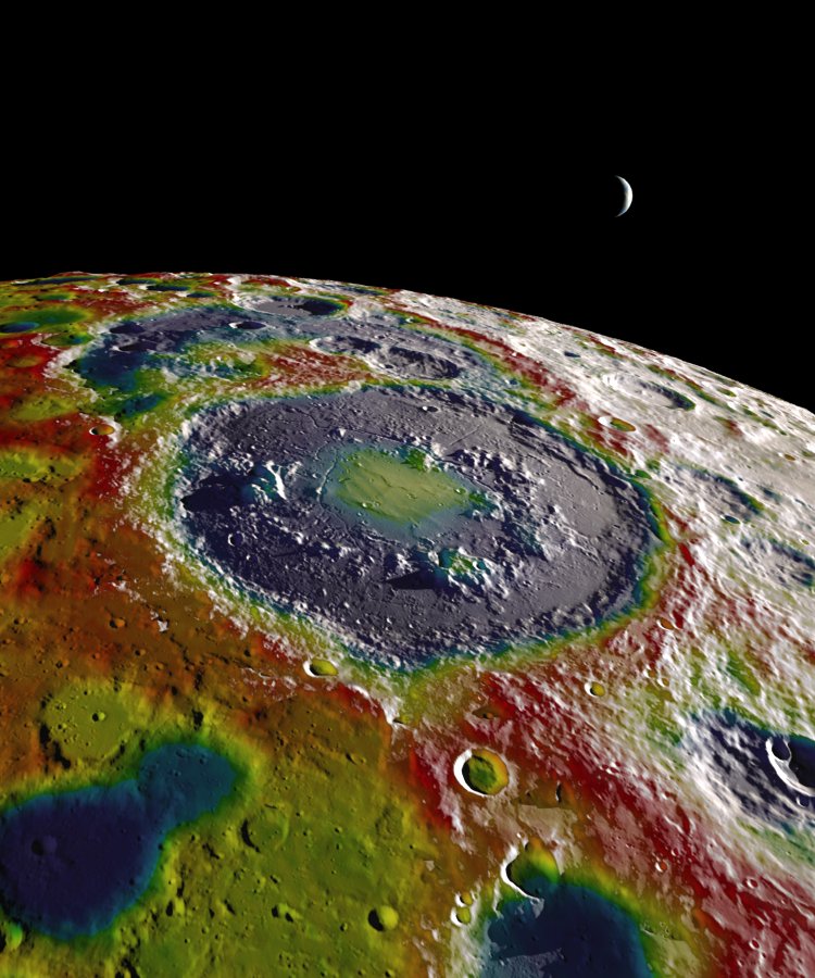 A high-resolution free-air gravity map based on GRAIL data, overlaid on terrain based on LRO altimeter (LOLA) and camera (LROC) data. The view is south-up, with the south pole near the horizon in the upper left and the crescent Earth in the distance. The terminator crosses the eastern rim of the Schrödinger basin. Gravity is painted onto the areas that are in or near the night side. Red corresponds to mass excesses and blue to mass deficits.