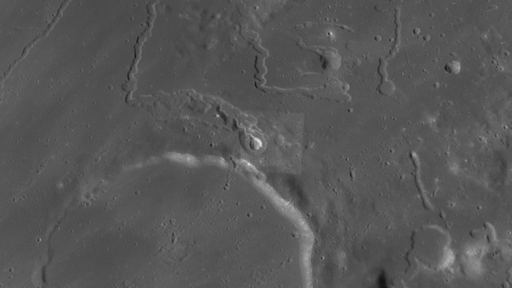 The camera zooms from an overhead, global view centered on the northern rim of Prinz crater, at 26.3°N 43.7°W, down to an oblique, close-up view of Vera crater and the associated rille, Rima Prinz.