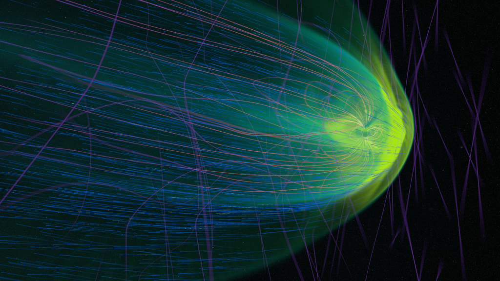 This animation demonstrates the Earth’s magnetosphere being hit by a geomagnetic storm on February 3, 2020, simulated by MAGE during the storm that caused the loss of commercial satellites.The green current density shows where magnetic current is strong. Lines tracing out the magnetic field are purple in regions of weaker magnetism, and orange-yellow where the magnetic field is strongest. Blue tracers in the velocity field represent the solar wind, and they have been calibrated to appear brightest when they are moving toward the Earth.