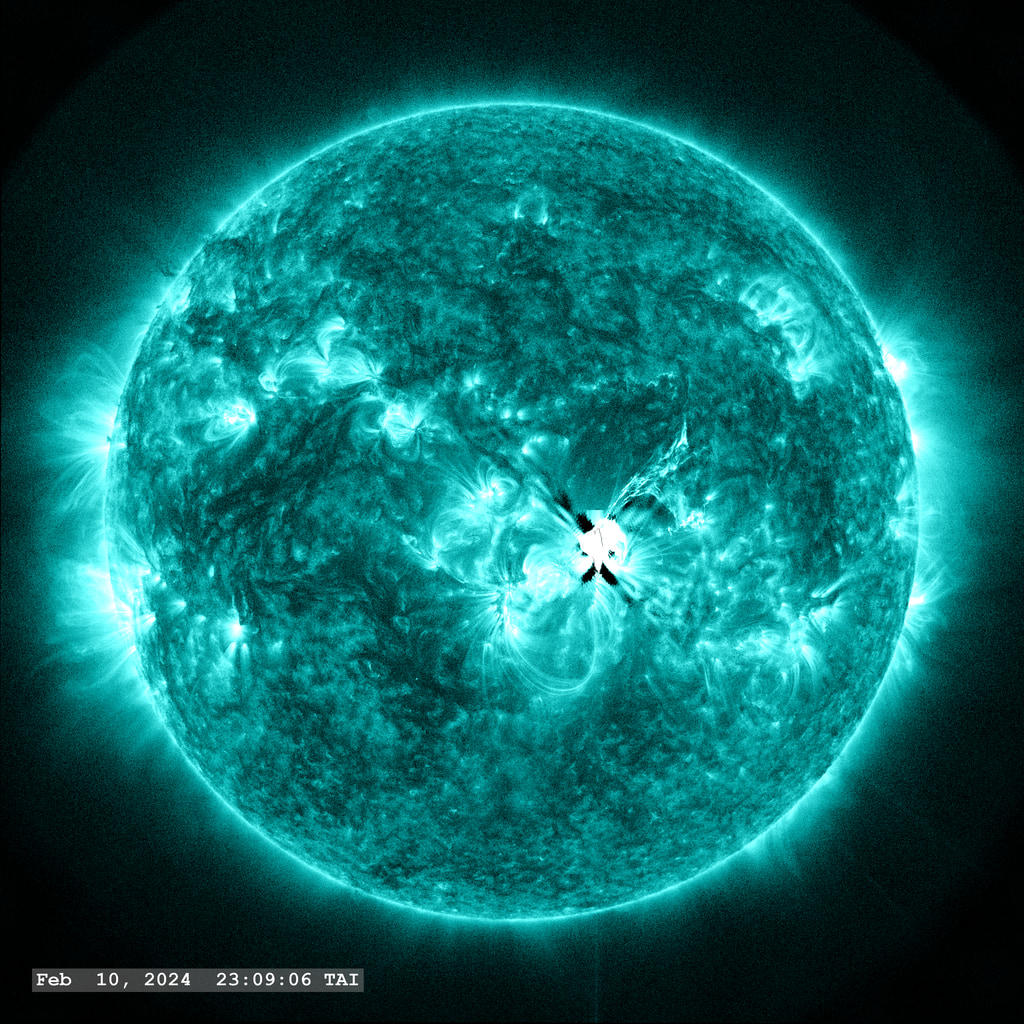 Active Region 13576 near the center of the solar disk, launches an M9.0 class flare in this view through the SDO/AIA 131 angstrom filter.   A bright filament of plasma is launched to the upper right from the site of the event.