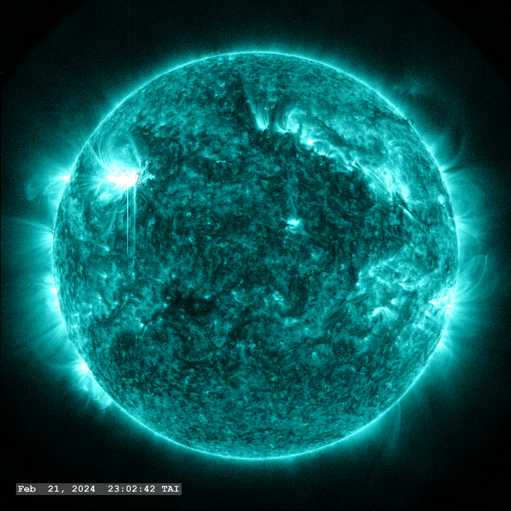 An X 1.8 flare erupts from Active Region 13590 in the upper left quadrant of the image in this view from SDO/AIA 131 angstrom filter. The point-spread function correction (PSF) has been applied to all this imagery.