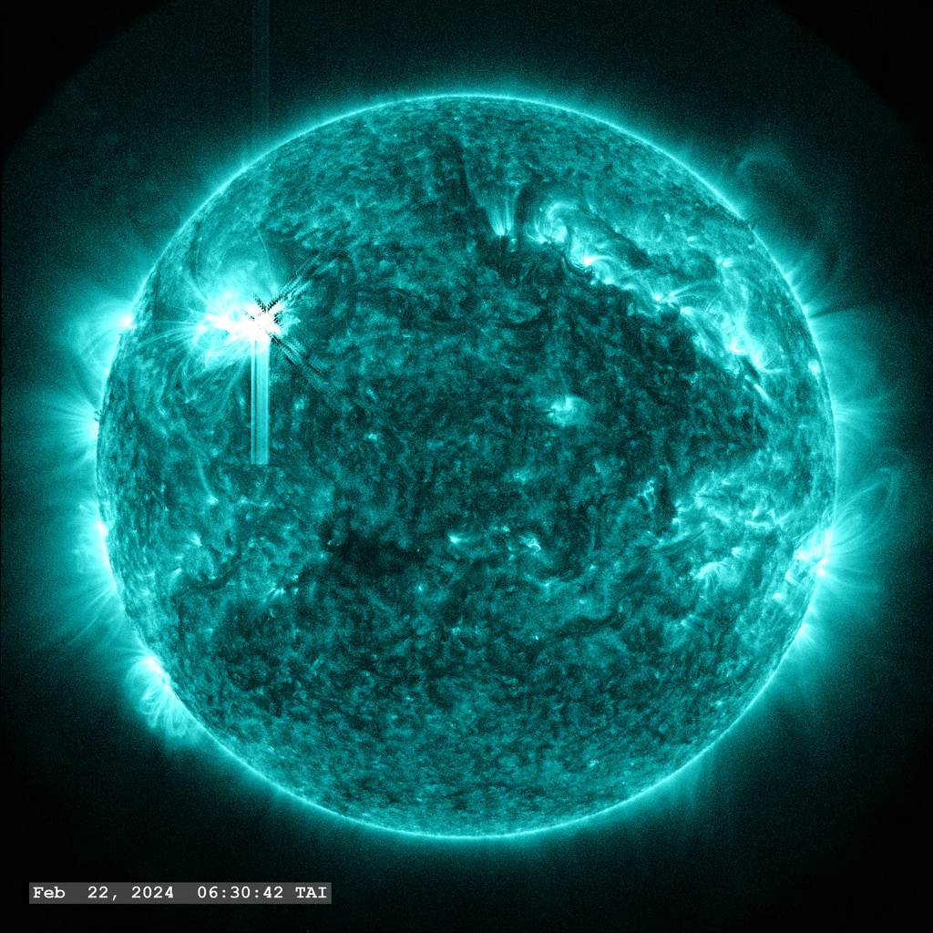 An X 1.7 flare erupts from Active Region 13590 in the upper left quadrant of the image in this view from SDO/AIA 131 angstrom filter. The point-spread function correction (PSF) has been applied to all this imagery.