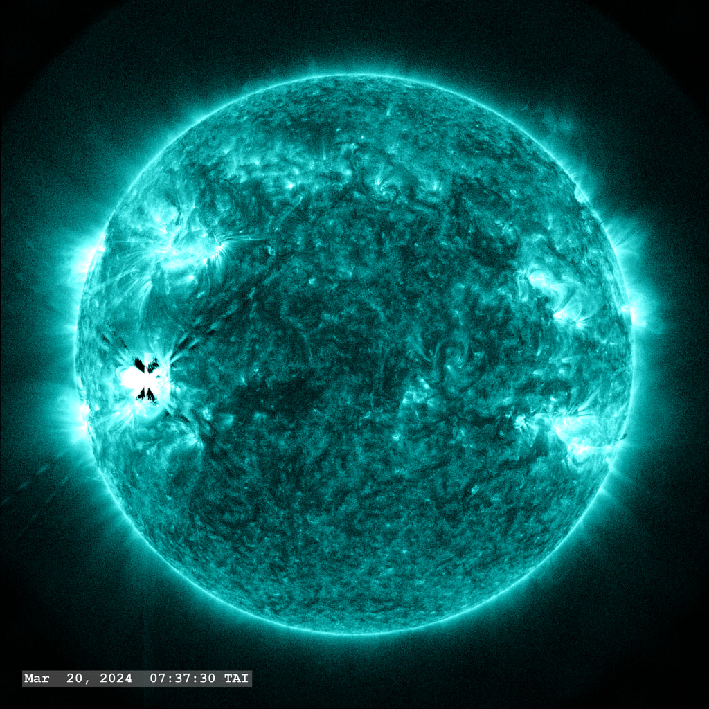 An M7.4 flare erupts from Active Region 13615 in the lower left quadrant of the image in this view from SDO/AIA 131 angstrom filter. The point-spread function correction (PSF) has been applied to all this imagery.