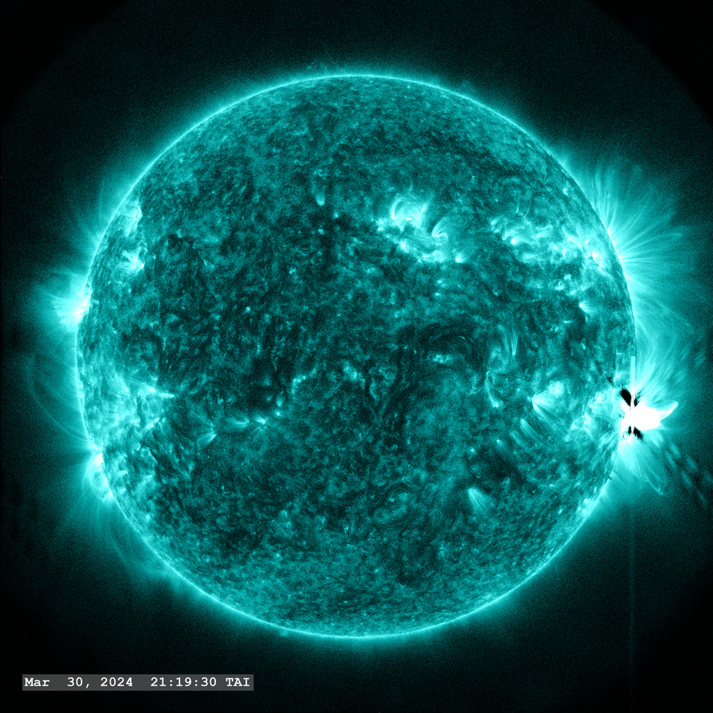 Active Region 13615 (center right limb) launches an M9.4 flare off the solar limb in this view through the SDO AIA 131 angstrom filter.