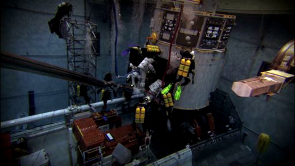 In planning for Servicing Mission 4 to Hubble, crew members divide their time between NASA's Johnson Space Center, Houston, working underwater on a Hubble mock-up to simulate the effects of weightlessness, and NASA's Goddard Space Flight Center, Greenbelt, Maryland, where they practice scheduled mission tasks on a Hubble mock-up inside a large clean room facility.  Many Goddard engineers are trained divers.  These engineers work along side the astronauts while in the Neutral Buoyancy Lab to aid in their training.  This underwater experience helps HST engineers understand what the astronauts need as they work together to refine tools and procedures to service Hubble.For complete transcript, click here.