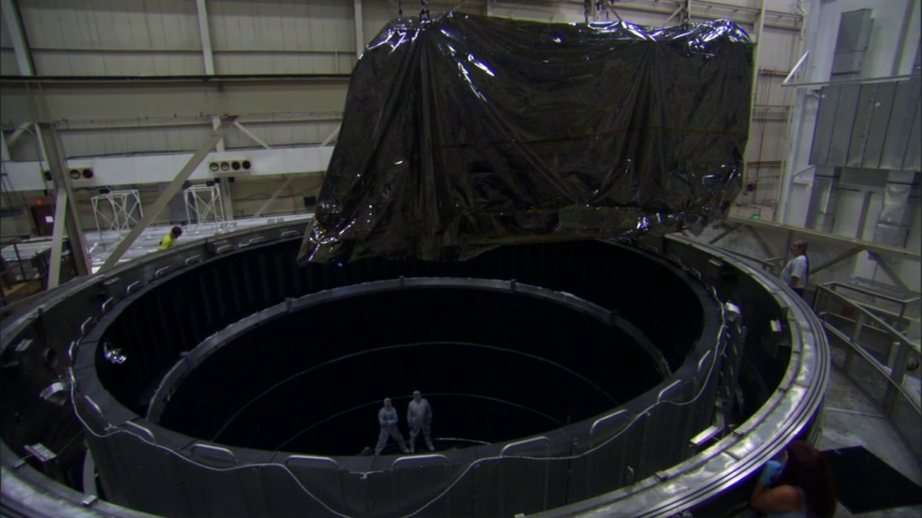 B-roll of NASA Goddard Space Flight Center engineers moving the Webb Telescope's ISIM into the space environment simulator.