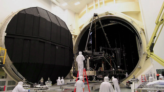 Inside NASA's giant thermal vacuum chamber, called Chamber A, at NASA's Johnson Space Center in Houston, the James Webb Space Telescope's Pathfinder backplane test model, is being prepared for its cryogenic test. Previously used for manned spaceflight missions, this historic chamber is now filled with engineers and technicians preparing for a crucial test.