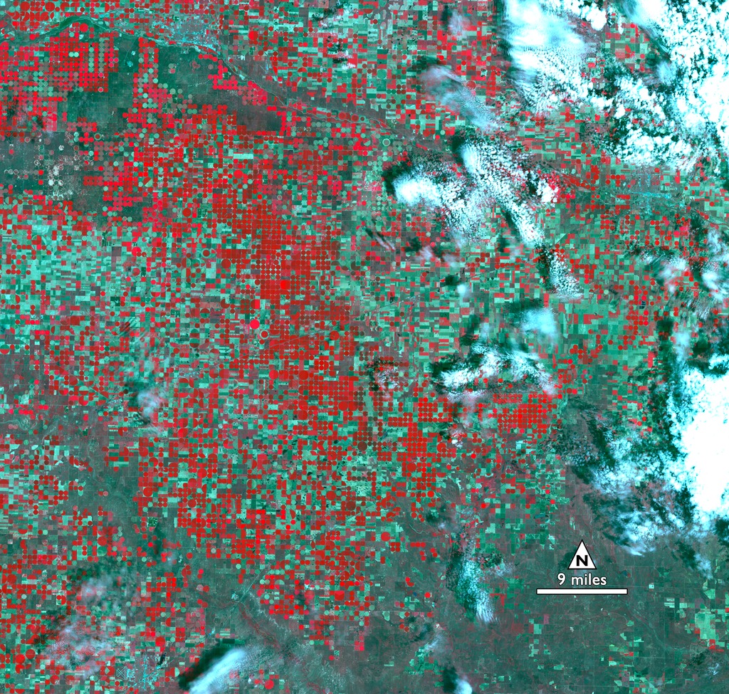 This image from 2015, and the accompanying images from 1972, 1988, and 2011 show the transformation of Kansas farmland from dryland, rectangular fields to circular irrigated fields from center-pivot irrigation systems. The mining of ground water for agriculture has been a significant trend globally over the last half-century, and these images of a region in Kansas highlight the trend within the United States. 