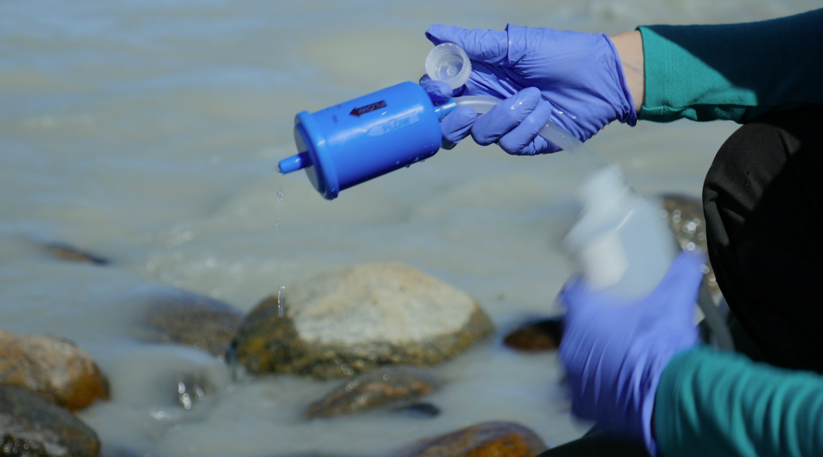 Grace Andrews and her colleague sample melt water originating from the Russell Glacier as part of a study on C02 evasion led by Andrew Jacobson from Northwestern University.