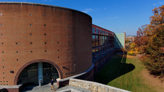 Views of the east side of Building 32 in morning light and fall colors. Several clips fly toward and away from the east entrance. The next set of clips rise to various heights above the building. The final shot stays above the building and pulls back, looking west. Captured Nov. 9, 2023.Credit: NASA/Francis Reddy