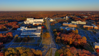 Views of the Goddard campus, from various heights, looking northeast from above Building 21, with fall colors in the late afternoon and magic hour. Several shots rise from below the tree line. Others fly forward or backward, looking toward the Integration and Test facilities prominent in the background.Credit: NASA/Francis Reddy