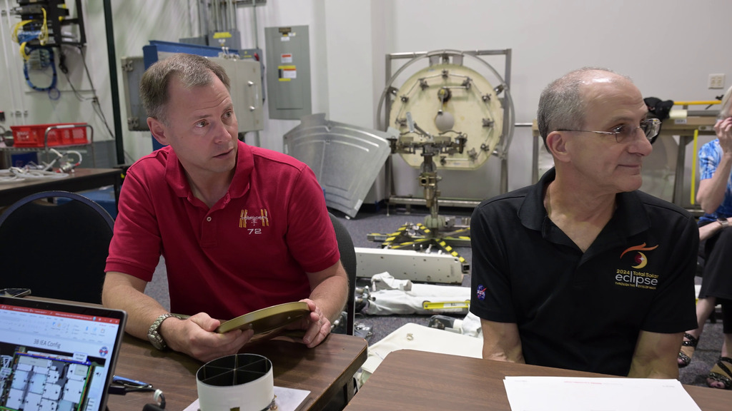 This video shows astronauts Don Pettit and Nick Hague attending a so-called 1-G briefing to learn about their NBL tasks for the following day. Spacewalk flight controllers Lucas Widner and Lauren Maples led the meeting, with NICER team members Keith Gendreau, Steve Kenyon, Elizabeth Ferrara, and Richard Koenecke in attendance.   

0:00 Hague, Pettit, Gendreau, Kenyon, Maples and Widner sit around a table and discuss the upcoming NBL tasks. 0:11 Closer shot of Hague and Pettit listening to the briefing. 0:24 Hague and Pettit examine mockups of the NICER pathes, sunshades, and caddy under Widner’s direction. 0:33 View of the 1-G briefing from another angle, behind the seated row of NICER team members. 0:46 Hague holds a flight space of the NICER thermal shields. 1:08: Gendreau talks to Hague and Pettit about the damage to NICER’s thermal shields. 1:35 Shot of Hague’s hand holding a 3D model of the NICER telescope. 1:51 Widner talks about the repair process. 2:00 Shot of the NICER mockups and flight spares used in the 1-G briefing. 2:06: Kenyon uses the 3D NICER model to demonstrates how it moves on the space station. 2:40 Ferrara demonstrates how the team labeled the positions for the NICER patches by counting rows and columns on the 3D model. 

Credit: NASA/Robert Markowitz